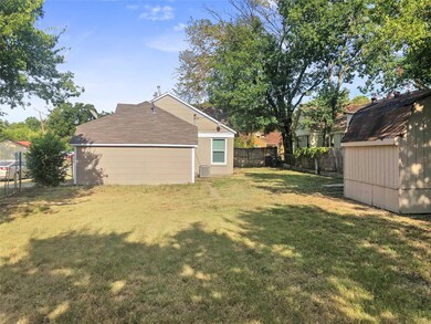 View of back yard featuring a shed!