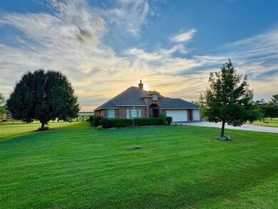 View of front of home with a front yard, concrete driveway, an attached garage, and a chimney