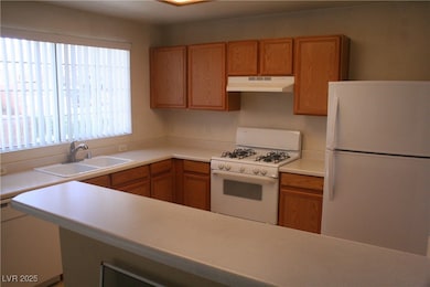 Kitchen with white appliances, light countertops,