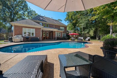 View of pool with area for grilling and a patio ar
