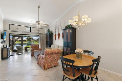 Dining room featuring ornamental molding, light tile patterned floors, ceiling fan, and a chandelier