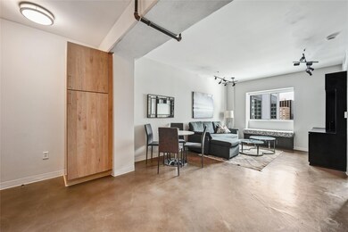 Living room featuring finished concrete flooring 