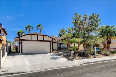 View of front of house with stucco siding, a garag