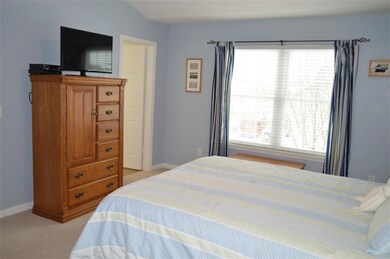 Bright and light master bedroom with attached bath, walk-in closet, and vaulted ceiling.