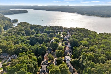Aerial perspective of suburban area featuring a water and mountain view and a heavily wooded area