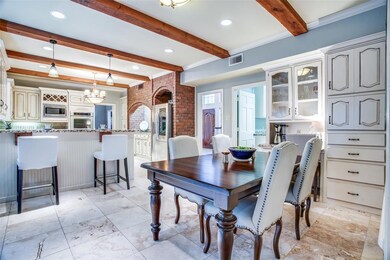 This kitchen and casual eating area is a show stopper! Beautiful ceiling beams, loads of storage, and stunning brick wall trim. Just a few of the special interior finishes throughout the home!