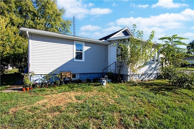 Rear view of house with a yard