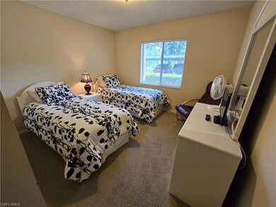 Carpeted bedroom featuring a textured ceiling