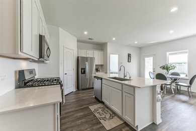 Storage beneath the island and farmhouse sink.