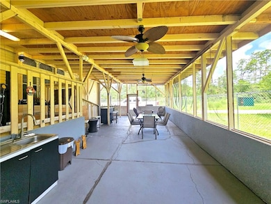 Sunroom / solarium with outdoor dining space and ceiling fan