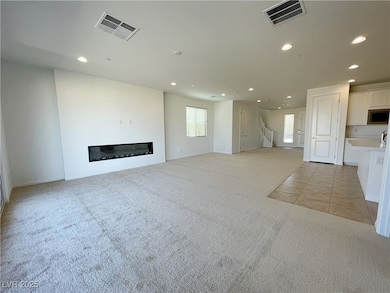 Unfurnished living room with recessed lighting, li
