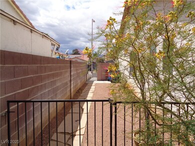View of yard featuring fence and a gate