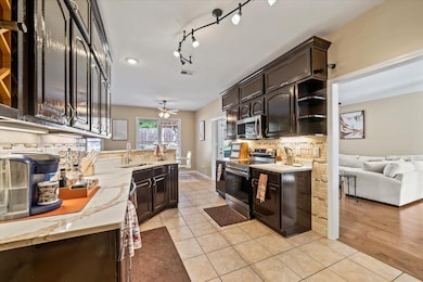 Kitchen with stainless steel appliances, open shel