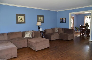 HUGE Living Room with Crown Molding & Refinished Hardwood Flooring.