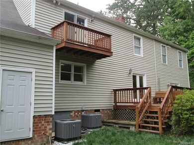 Balcony from master bedroom, as well as nicely sized rear deck, w/storage building attached to house.