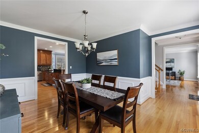 Formal dining room features hardwood floors, chand
