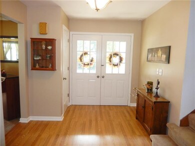 Hard wood floor entry with double doors and neutra