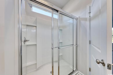 Full bathroom featuring a shower stall