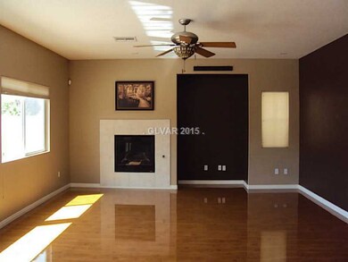 Property Photo. Living room with fireplace & fan