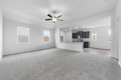 Unfurnished living room featuring healthy amount of natural light, light colored carpet, a ceiling fan, and recessed​​‌​​​​‌​​‌‌​​‌​​​‌‌​​​​​​‌‌‌​​‌​​‌‌​​​‌ lighting