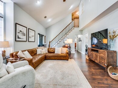 Living room with high vaulted ceiling and dark hardwood / wood-style flooring