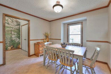 Dining room featuring ornamental molding, light ti