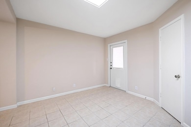 Unfurnished room with light tile patterned floors