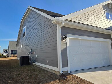 View of home's exterior featuring central AC and a
