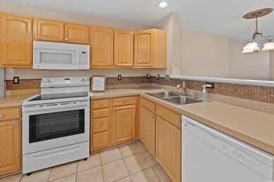 Kitchen with white appliances, decorative light fi