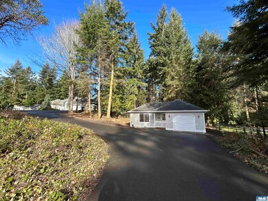 Paved drive past Guest Cottage to Main Home