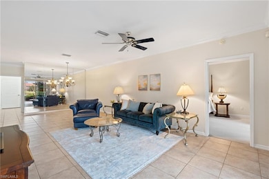 Living room featuring ceiling fan with notable cha