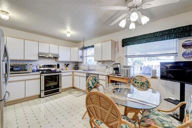 Large eat-in kitchen with 3 windows.