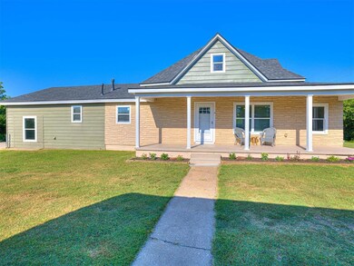 View of front of house with covered porch and a fr