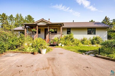 Ranch-style house with a tile roof and covered por