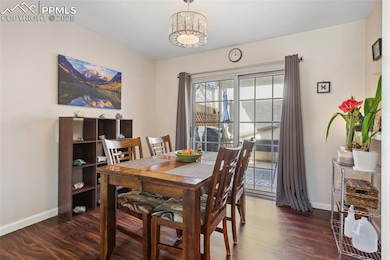 Dining area with baseboards and wood finished floo