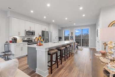 Kitchen with light wood finished floors, a sink, a