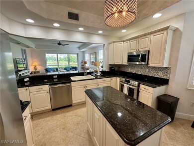 Kitchen featuring stainless steel appliances, a si