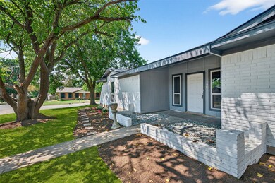 View of side of home with brick siding and a yard