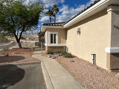 View of side of property featuring fence, stucco s