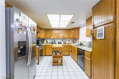 Kitchen with stainless steel appliances, light cou