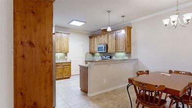 Kitchen featuring stainless steel microwave, a pen