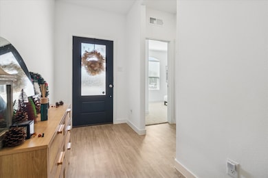 Foyer featuring baseboards and light wood-type flooring