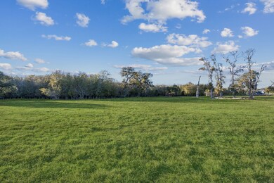 Take in the serene, tree-lined backdrop from your back porch, creating the perfect setting for privacy and tranquility.
