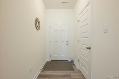Doorway to outside with hardwood / wood-style floo