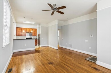 Unfurnished living room with wood-type flooring and ceiling fan
