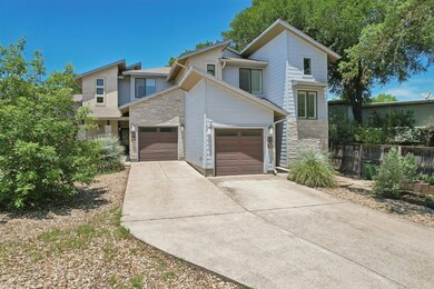 Contemporary home featuring stone siding, an atta