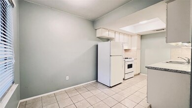 Kitchen with white appliances, visible vents, a s