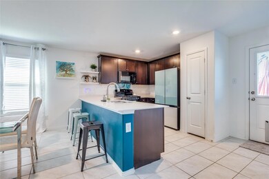 Kitchen featuring dark brown cabinets, a breakfast