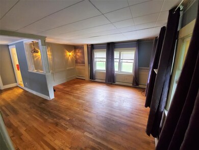 Large living room with hard wood flooring.