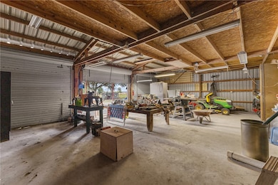 Garage featuring metal wall and a workshop area